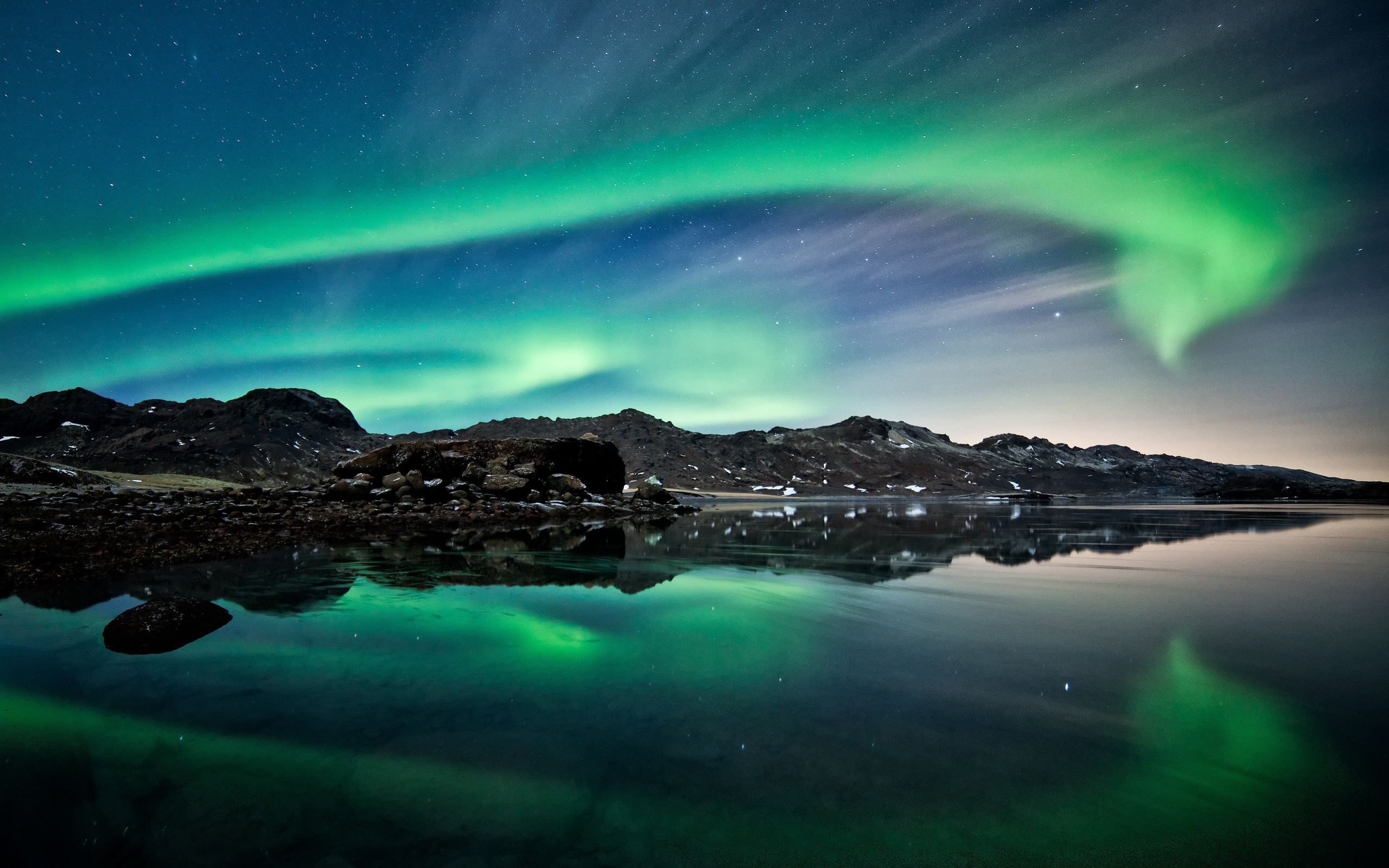 Aurora Borealis over mountains and water