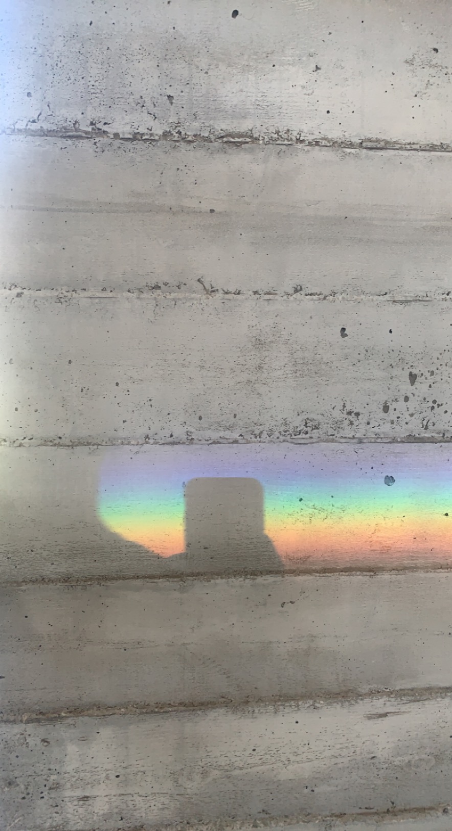 Creative study - Rainbow light projection on concrete wall